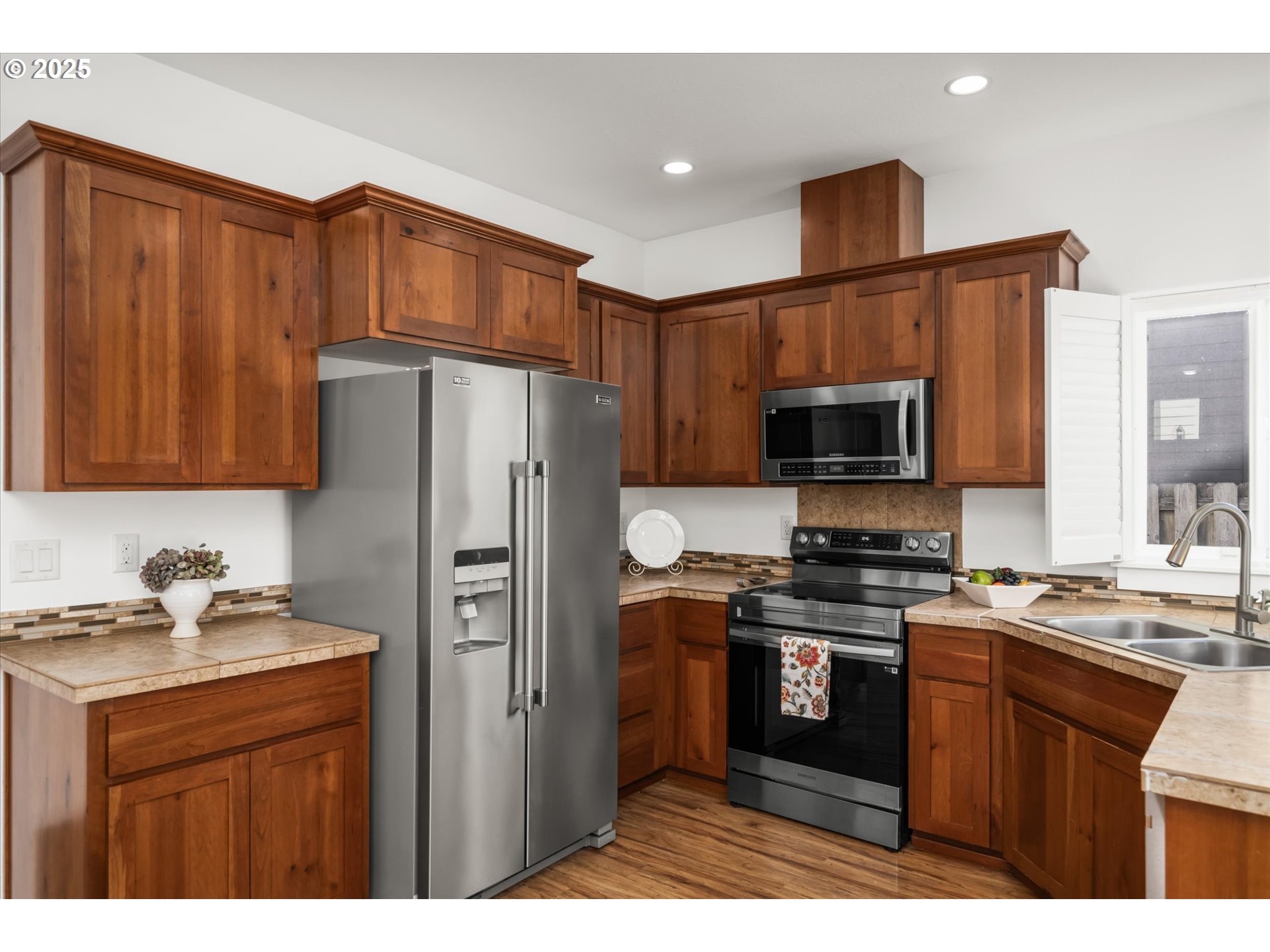 536 Raber Road Eugene, OR 97402 - Photo 15 of 41 a kitchen with stainless steel appliances granite countertop a refrigerator stove a sink dishwasher and wooden cabinets
