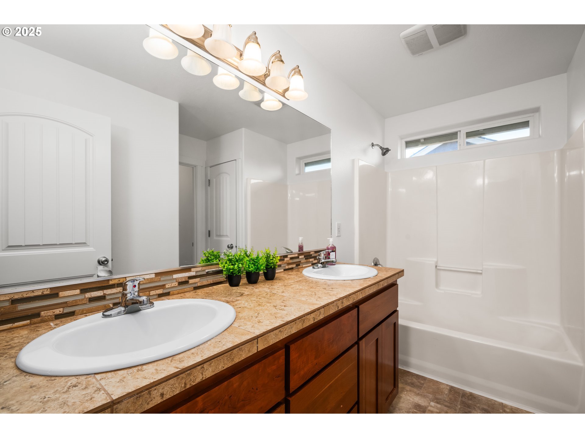 536 Raber Road Eugene, OR 97402 - Photo 22 of 41 a bathroom with a sink double vanity granite tub shower and a mirror