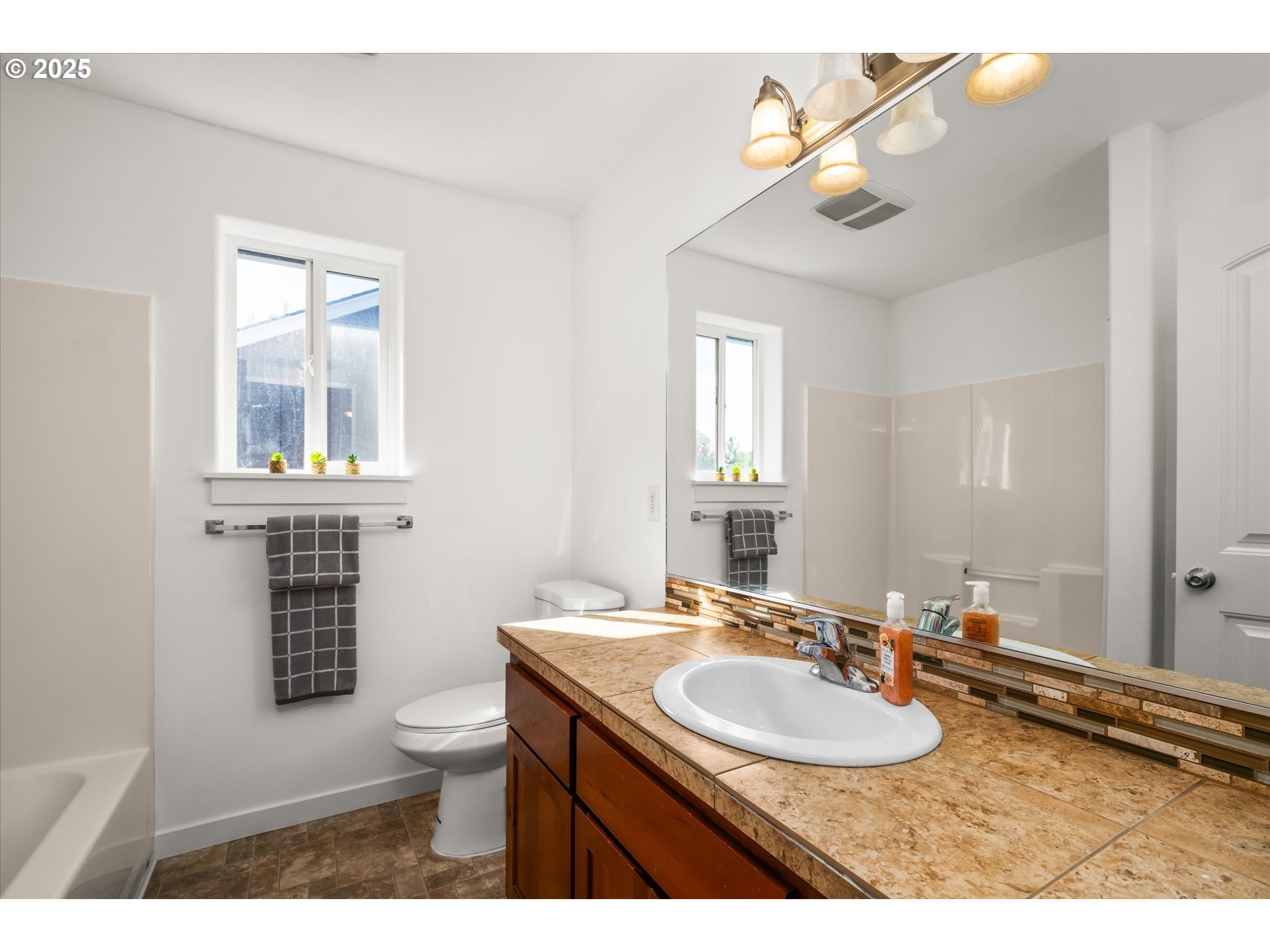 536 Raber Road Eugene, OR 97402 - Photo 24 of 41 a bathroom with a sink a toilet and a mirror