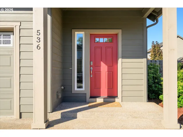 a view of a house with a door and a yard