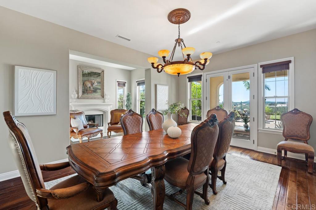 14844 Whispering Ridge Road San Diego, CA 92131 - Photo 18 of 73 a view of a dining room with furniture window and wooden floor