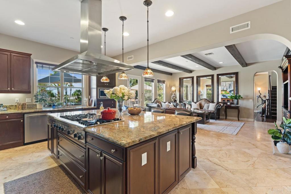 14844 Whispering Ridge Road San Diego, CA 92131 - Photo 23 of 73 a kitchen with stainless steel appliances granite countertop a lot of counter space and a sink