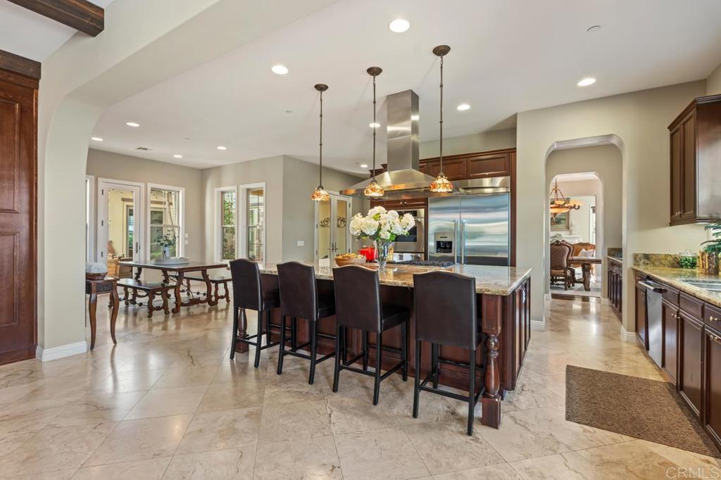 14844 Whispering Ridge Road San Diego, CA 92131 - Photo 26 of 73 a large kitchen with lots of furniture and dining table