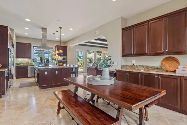 a kitchen with stainless steel appliances granite countertop a sink dishwasher and cabinets with wooden floor
