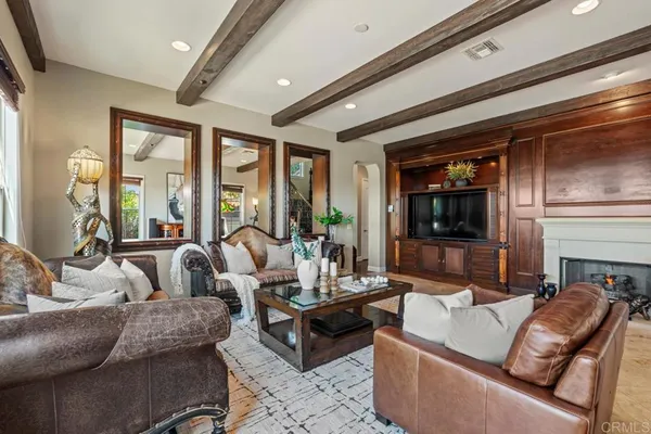 a view of a patio with a dining table and chairs under an umbrella with potted plants