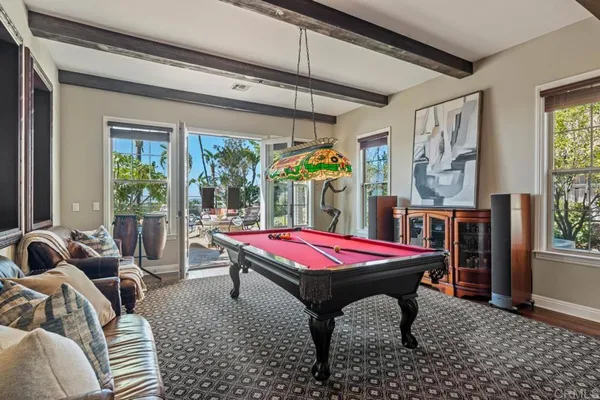 an aerial view of a house with swimming pool and outdoor seating