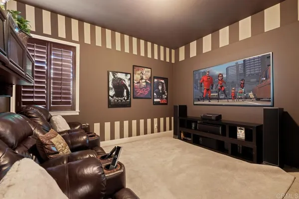 a living room with furniture a fireplace and chandelier