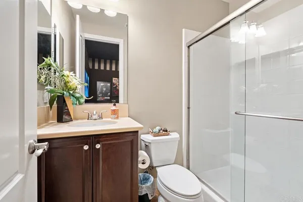 a bedroom with a bed couch chandelier and window