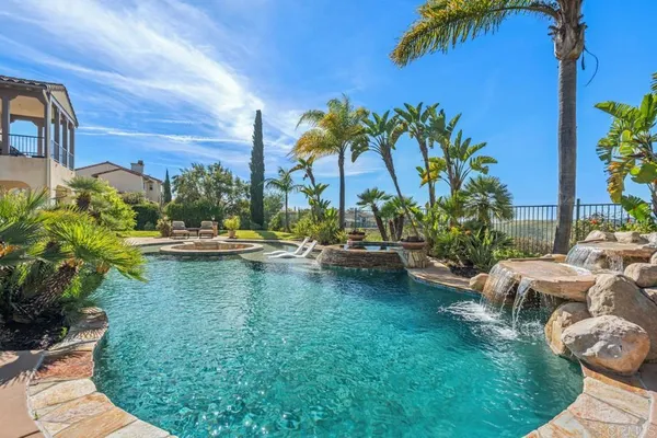a bathroom with a granite countertop shower a sink and a mirror