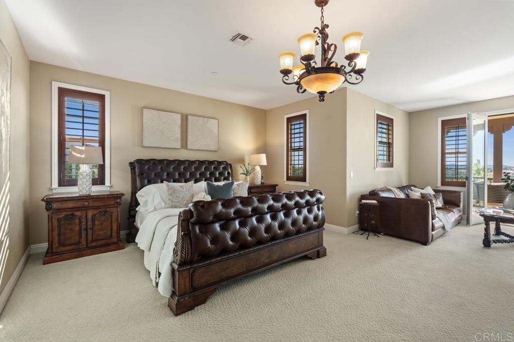 14844 Whispering Ridge Road San Diego, CA 92131 - Photo 50 of 73 a bedroom with a bed couch chandelier and window