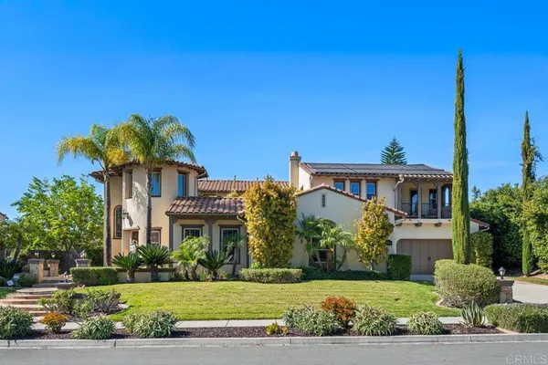 an aerial view of residential houses with outdoor space and ocean view