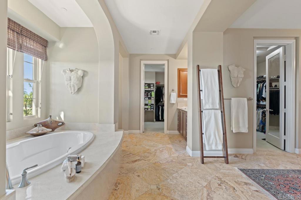 14844 Whispering Ridge Road San Diego, CA 92131 - Photo 55 of 73 a spacious bathroom with a tub and a sink