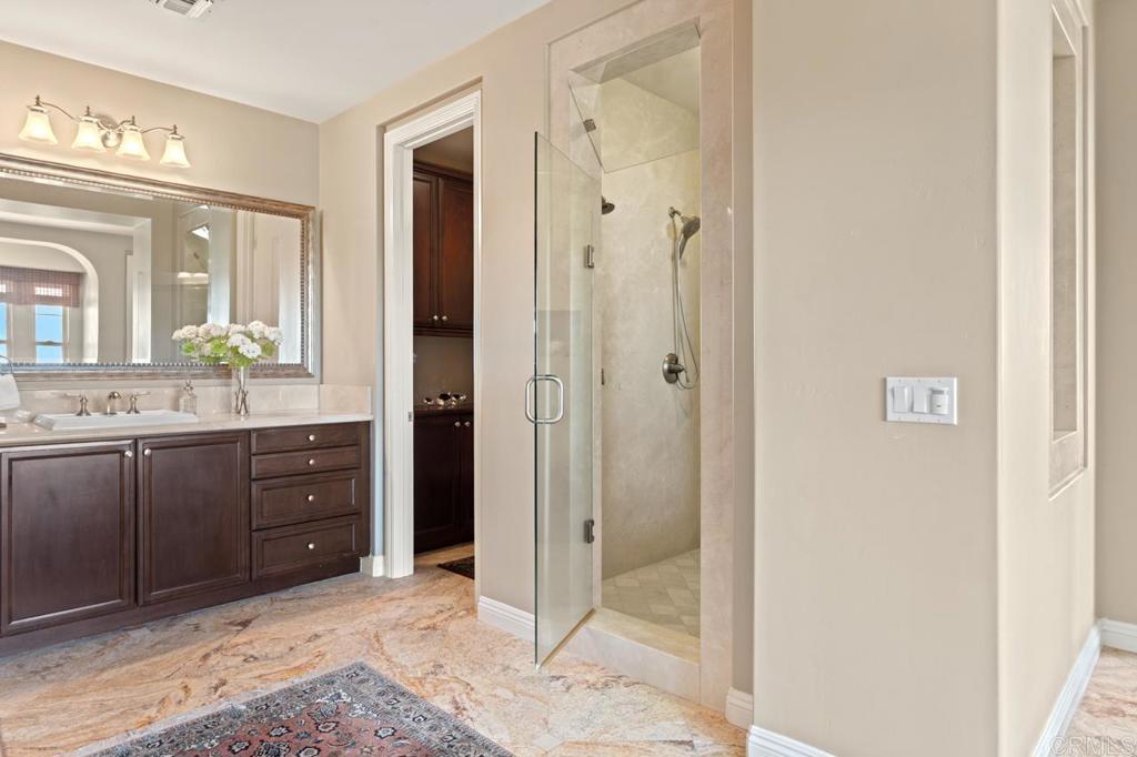 14844 Whispering Ridge Road San Diego, CA 92131 - Photo 58 of 73 a spacious bathroom with a mirror and a shower