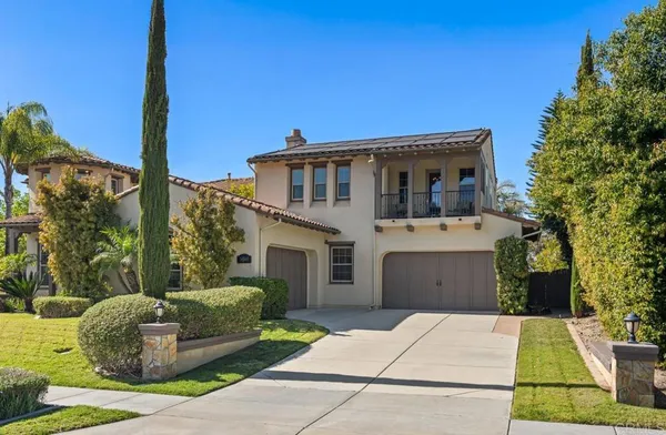 a living room with furniture a fireplace and a large window