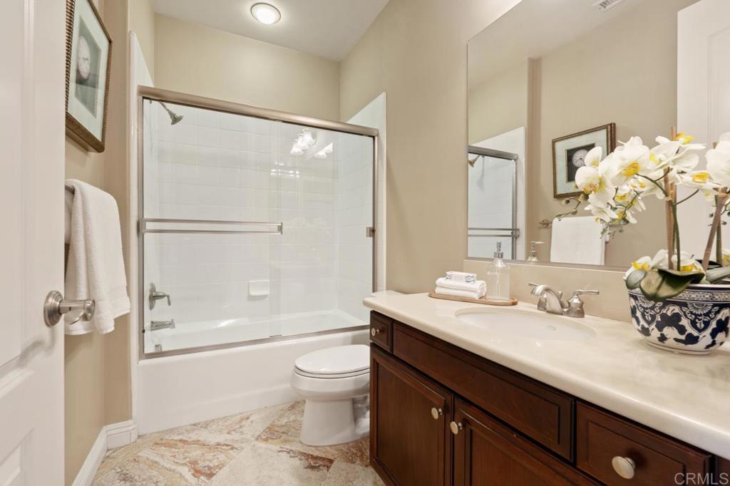 14844 Whispering Ridge Road San Diego, CA 92131 - Photo 67 of 73 a bathroom with a sink a toilet and shower