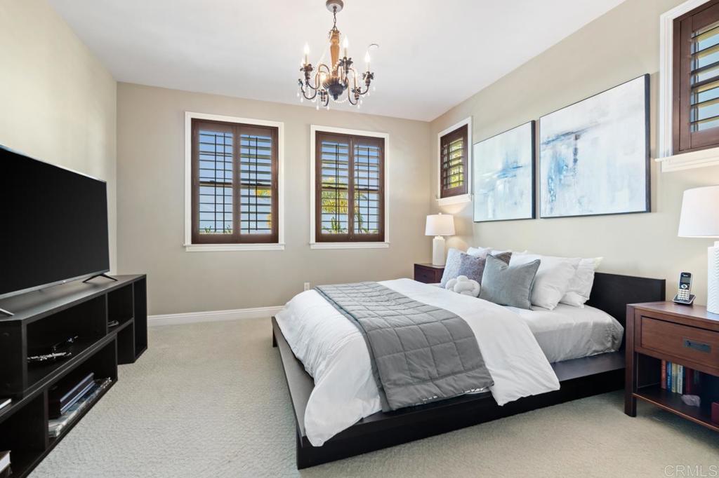 14844 Whispering Ridge Road San Diego, CA 92131 - Photo 68 of 73 a bedroom with a bed and a flat screen tv on dresser