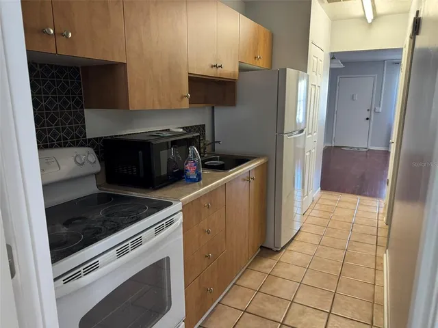 a kitchen with a sink and refrigerator