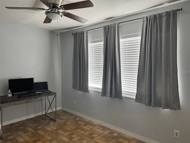 a living room with a flat screen tv and white wall