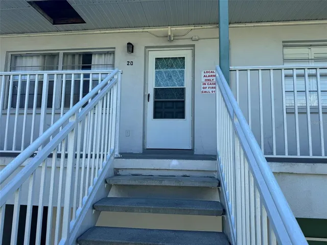a view of staircase with wooden floor and white walls
