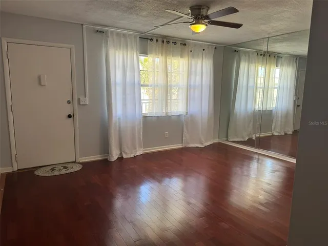 a white toilet sitting next to a shower curtain