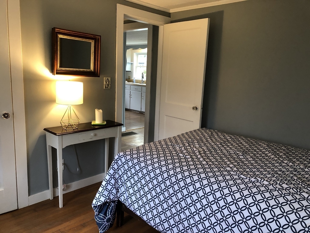 14 Bayberry Road Bourne, MA 02532 - Photo 9 of 16 a bedroom with a bed and wooden floor