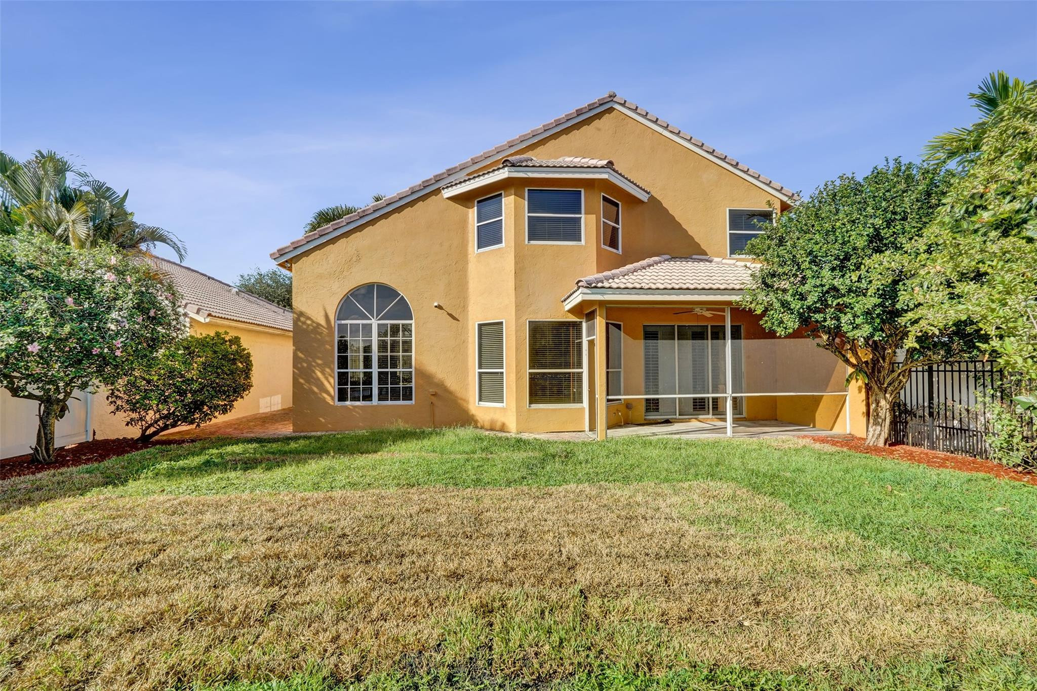 10902 Tamoron Lane Boca Raton, FL 33498 - Photo 61 of 66 a front view of a house with a yard and garage