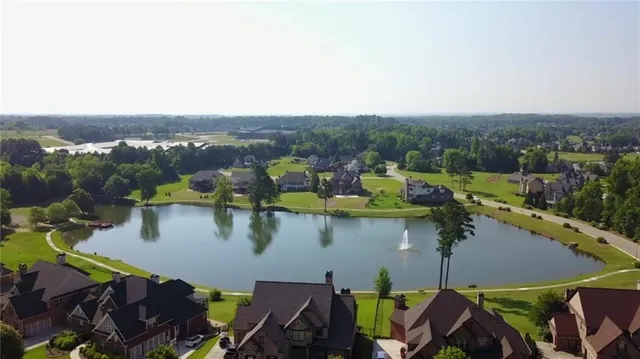 an aerial view of a house with a swimming pool outdoor seating and yard