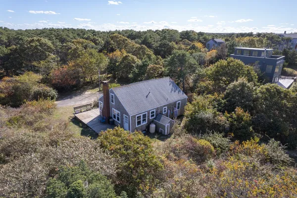 an aerial view of a house with a yard