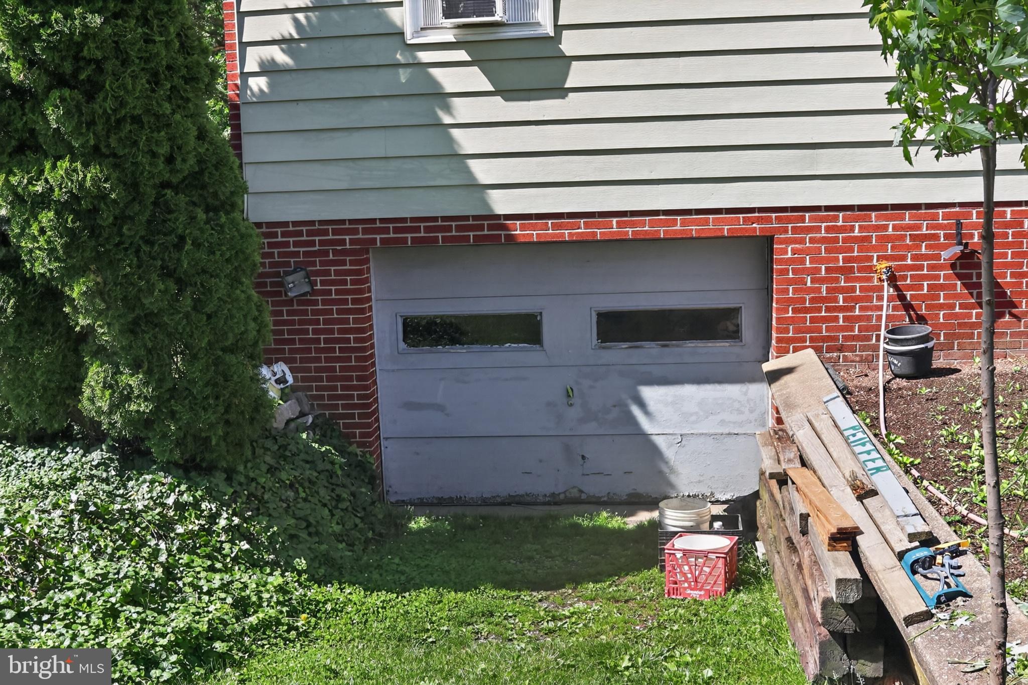 1106 Village Road Lancaster, PA 17602 - Photo 38 of 42 Charming garage with lush greenery.