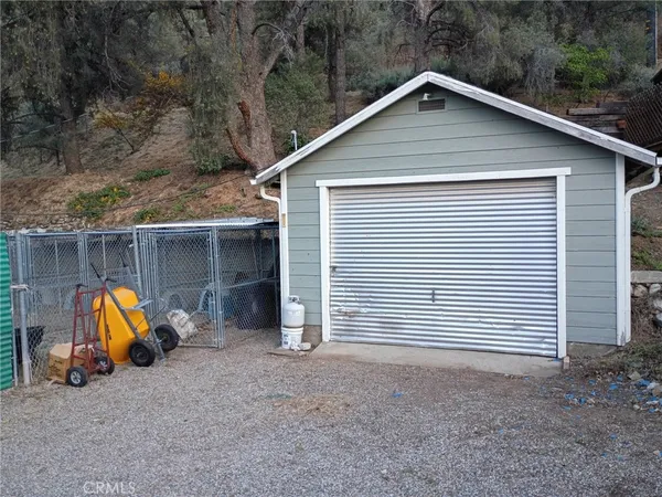 a view of a house with a yard and a wooden bench