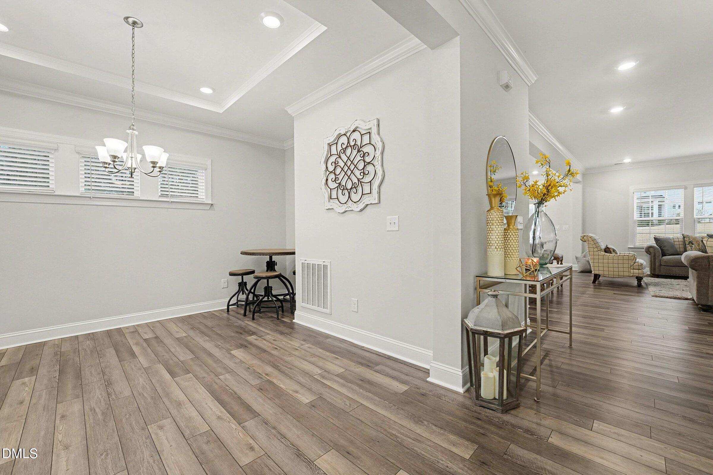 183 Axis Deer Lane Garner, NC 27529 - Photo 15 of 35 a view of livingroom with dining room and wooden floor