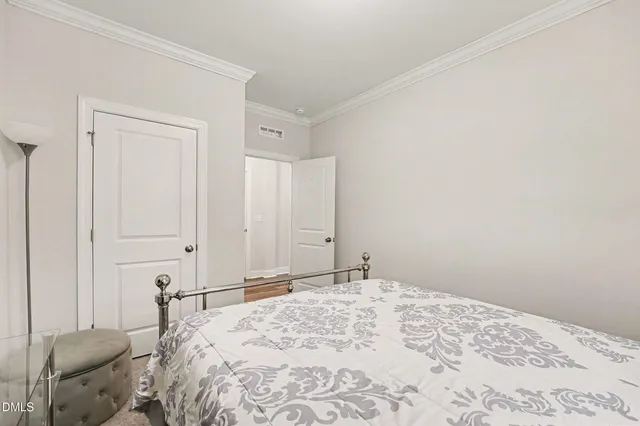 a bedroom with a bed and a chair