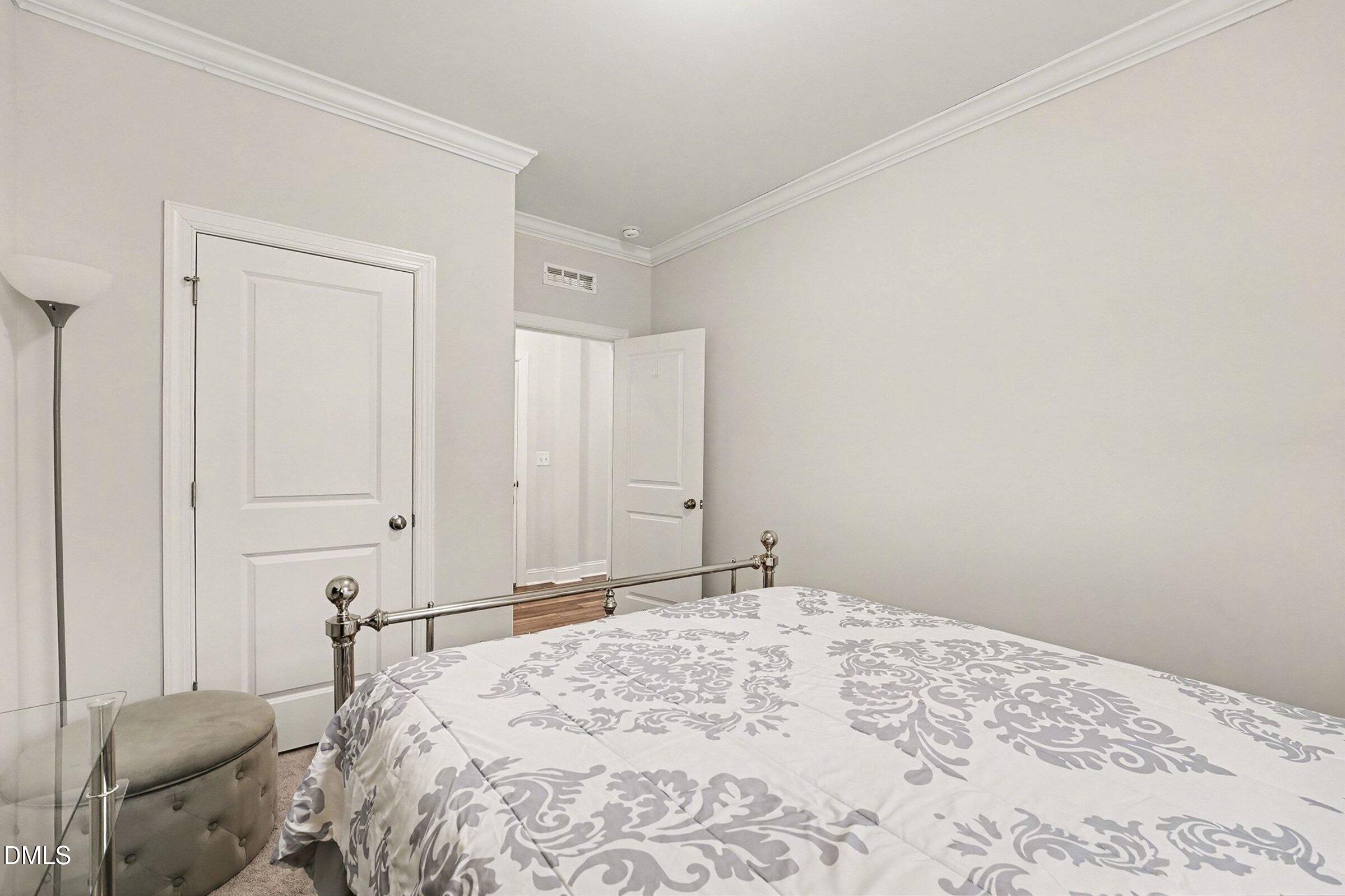 183 Axis Deer Lane Garner, NC 27529 - Photo 17 of 35 a bedroom with a bed and a chair