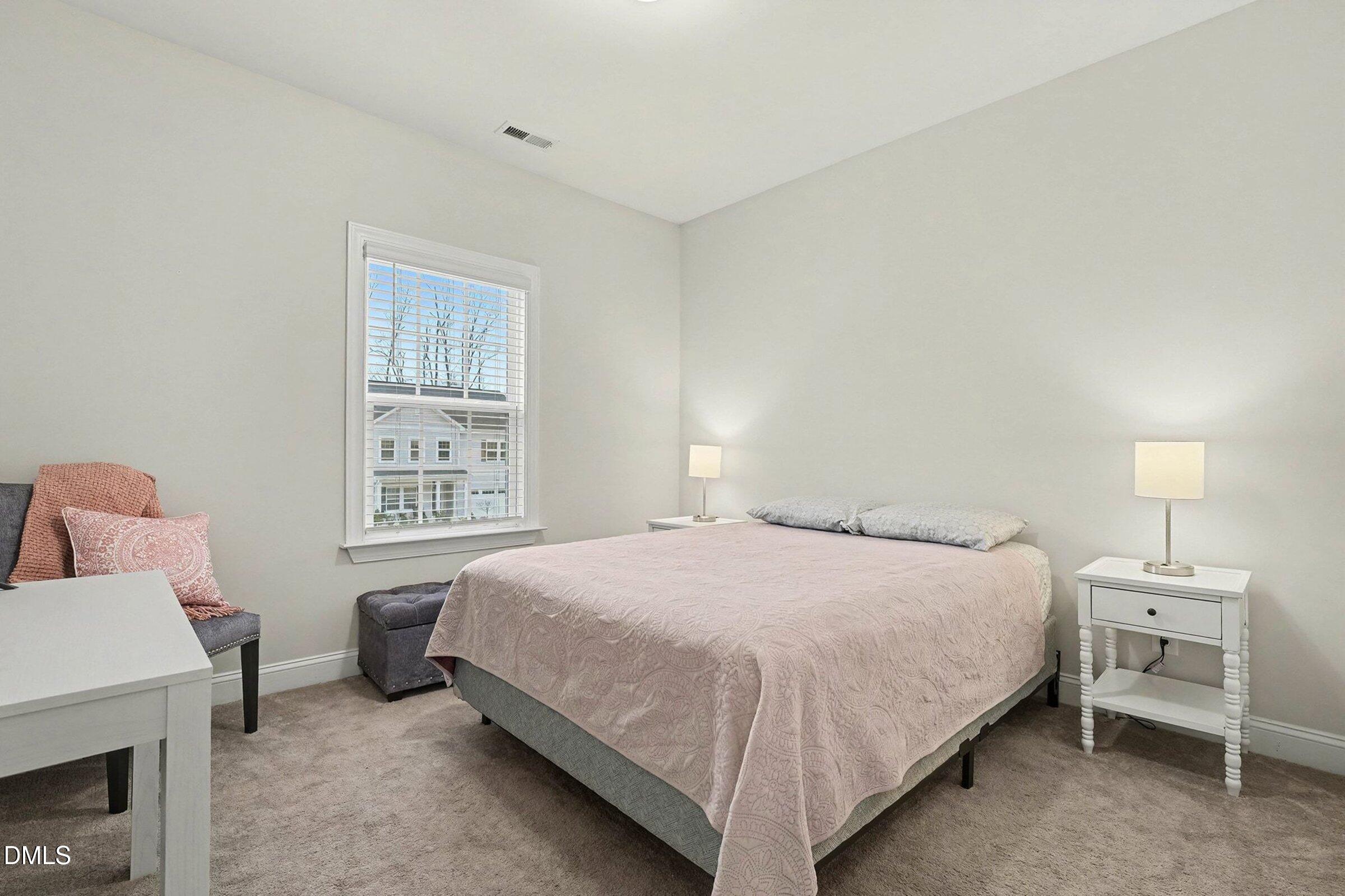 183 Axis Deer Lane Garner, NC 27529 - Photo 21 of 35 a bedroom with a bed and a window