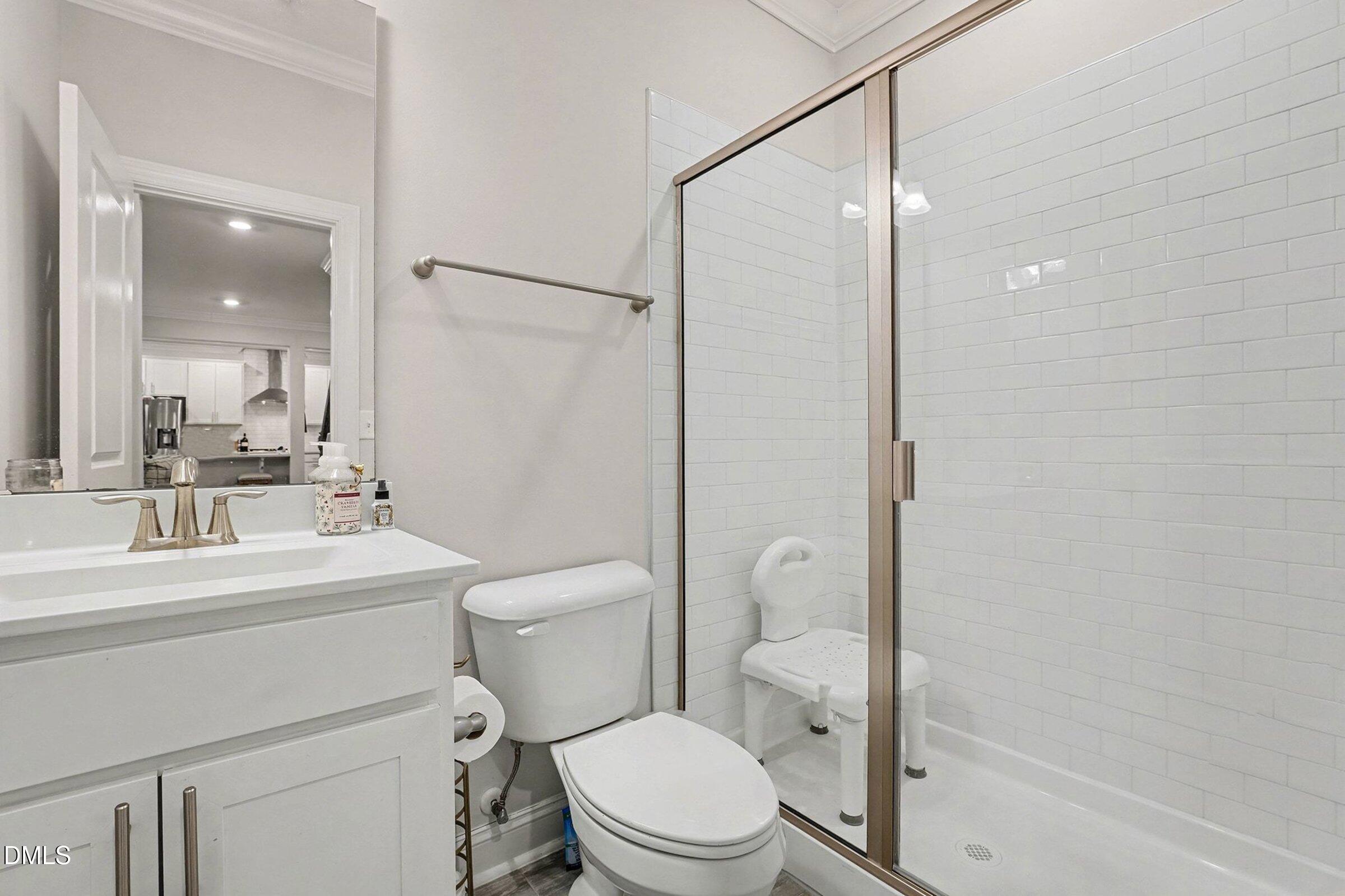 183 Axis Deer Lane Garner, NC 27529 - Photo 23 of 35 a bathroom with a sink a toilet a mirror and shower