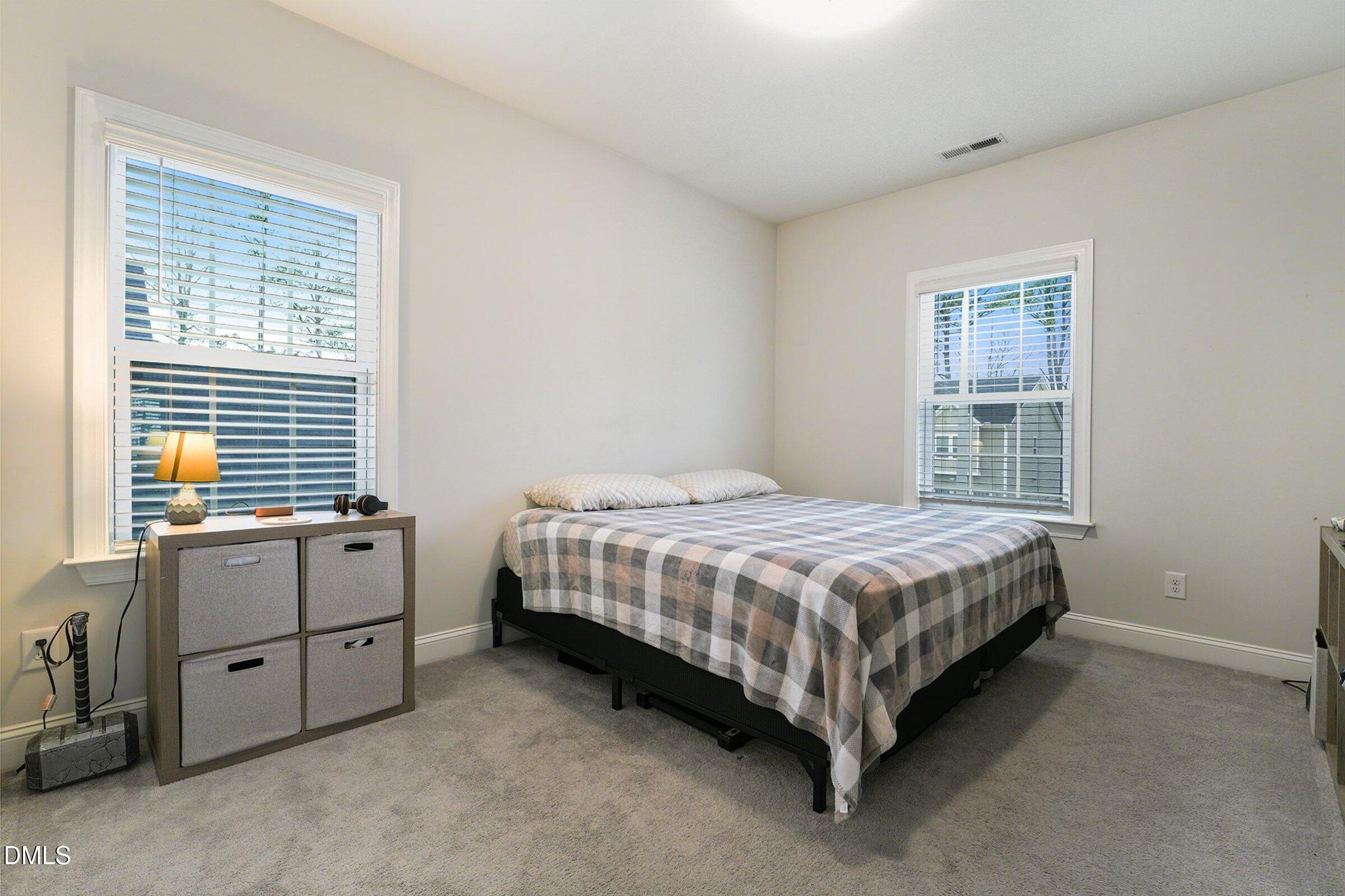 183 Axis Deer Lane Garner, NC 27529 - Photo 24 of 35 a bed room with a bed and a window