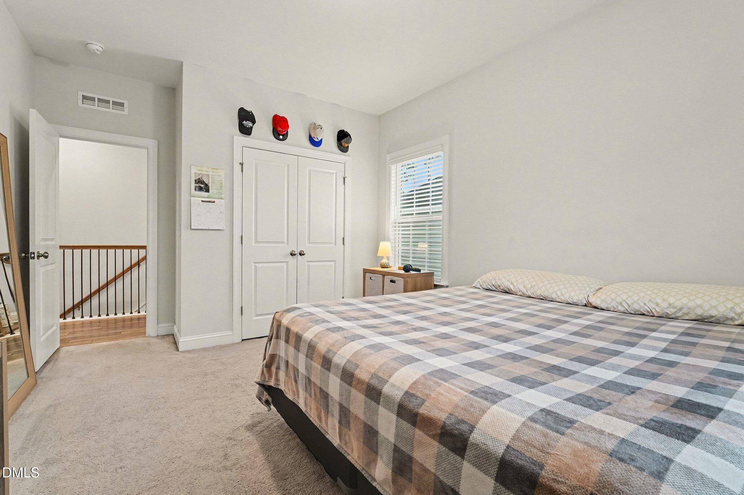 183 Axis Deer Lane Garner, NC 27529 - Photo 25 of 35 a bedroom with a bed and a window