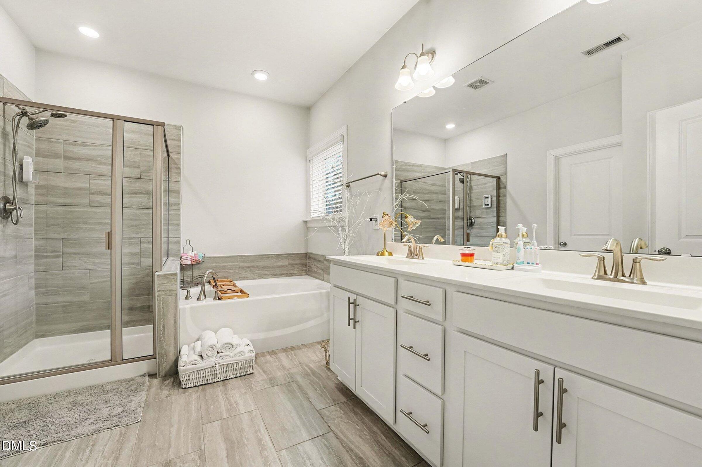 183 Axis Deer Lane Garner, NC 27529 - Photo 27 of 35 a bathroom with a double vanity sink mirror and shower