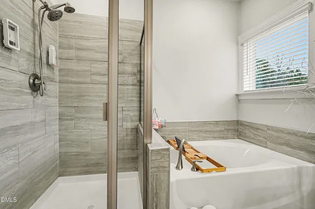 a bathroom with a bathtub and shower