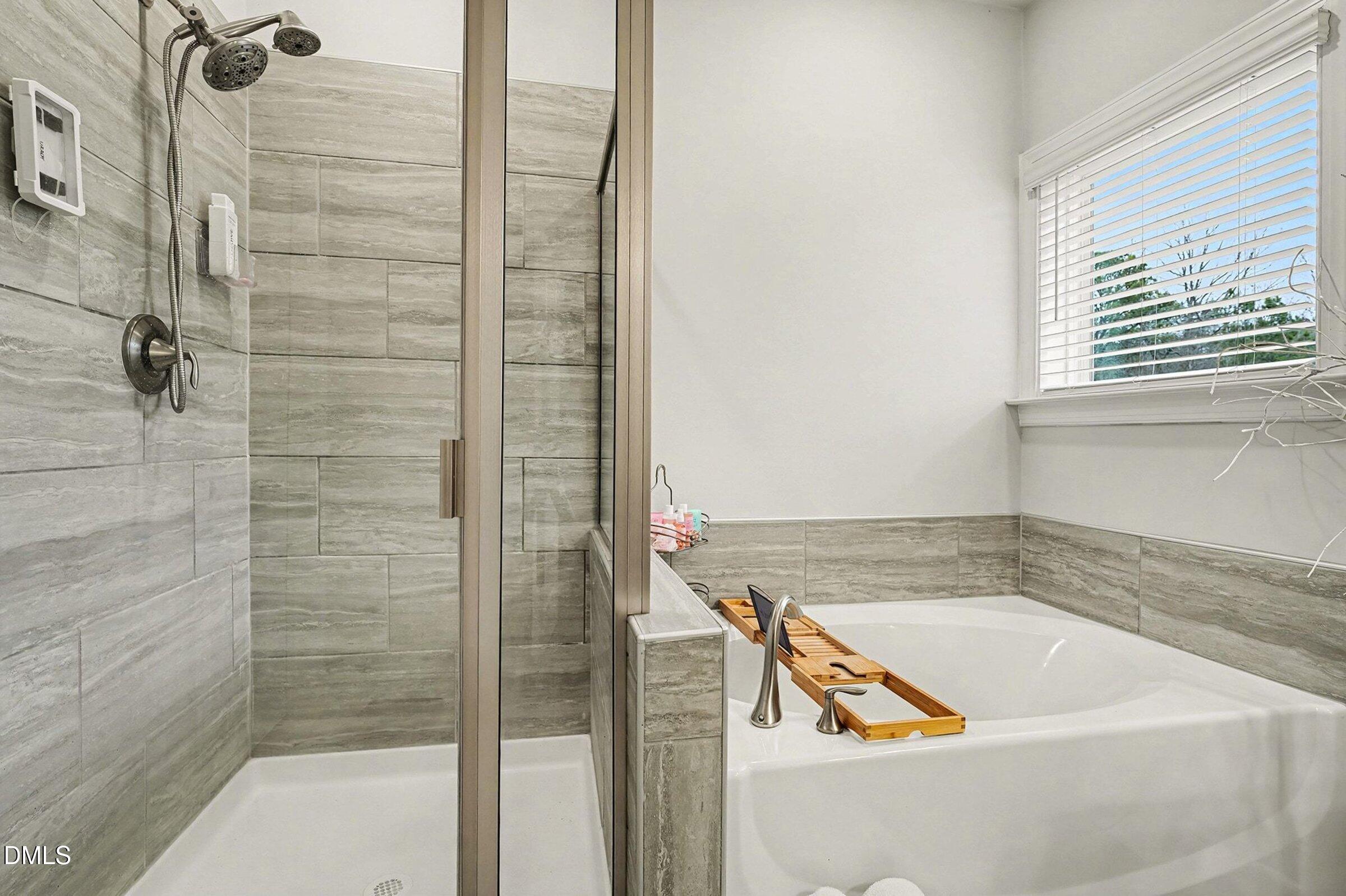 183 Axis Deer Lane Garner, NC 27529 - Photo 28 of 35 a bathroom with a bathtub and shower