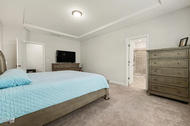 a bedroom with a bed and mirror