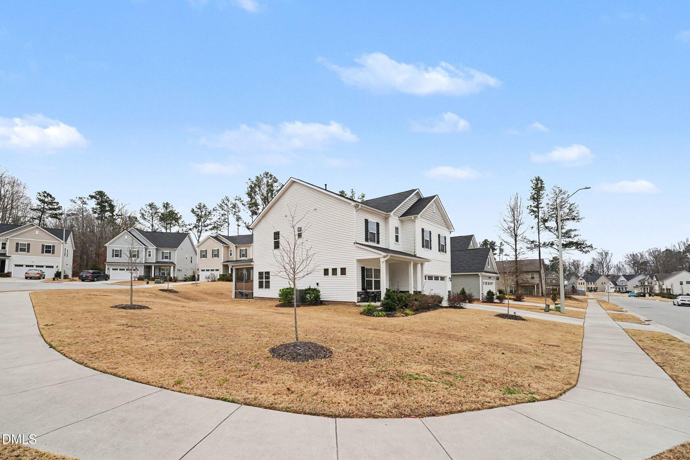 183 Axis Deer Lane Garner, NC 27529 - Photo 3 of 35 a view of a white house with a yard