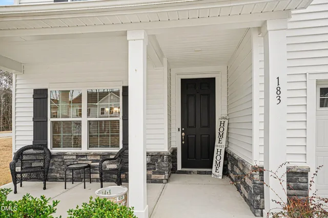 a porch with outdoor seating