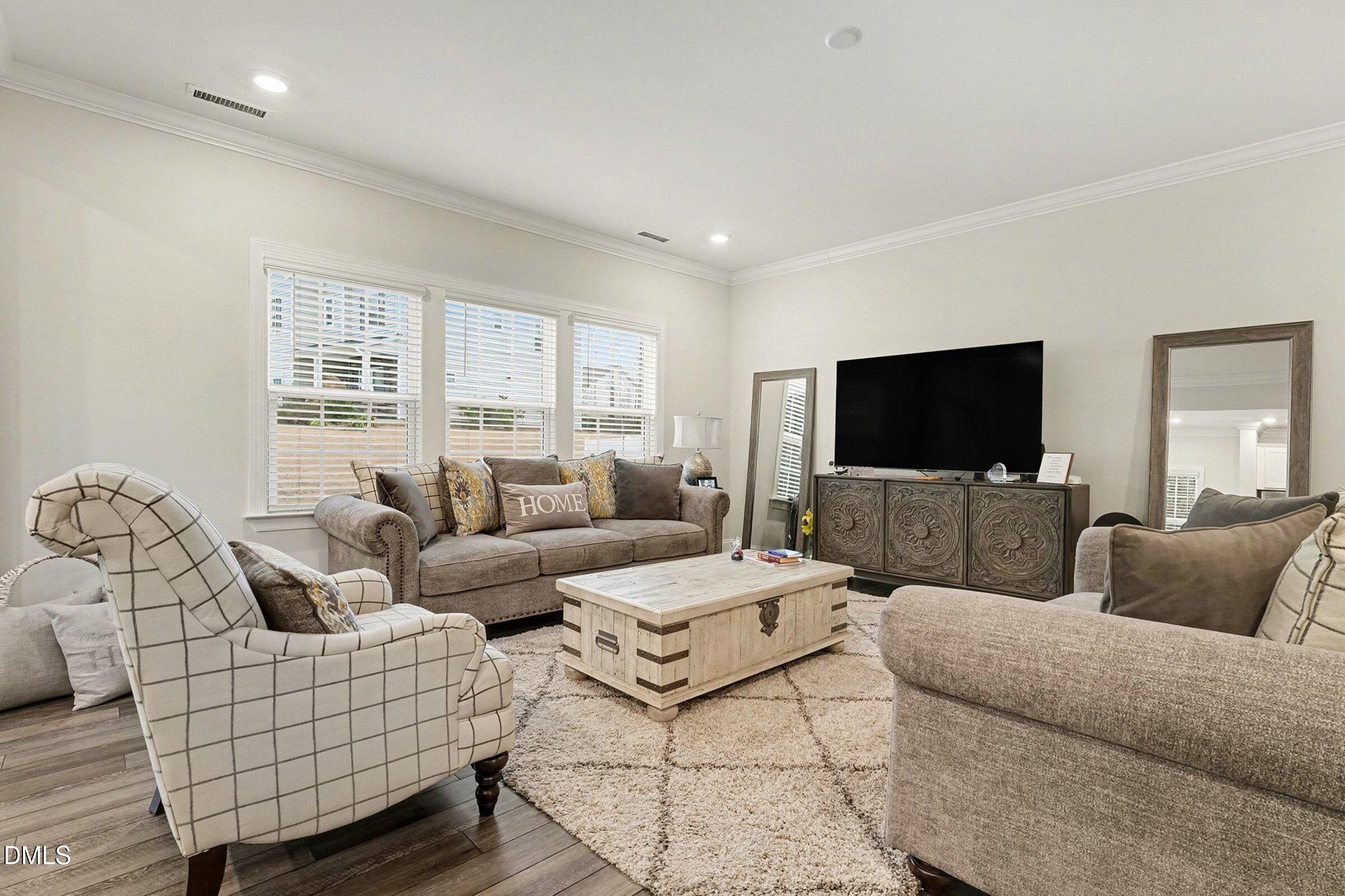 183 Axis Deer Lane Garner, NC 27529 - Photo 8 of 35 a living room with furniture and a flat screen tv