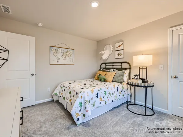 a bedroom with a bed and painting on the wall