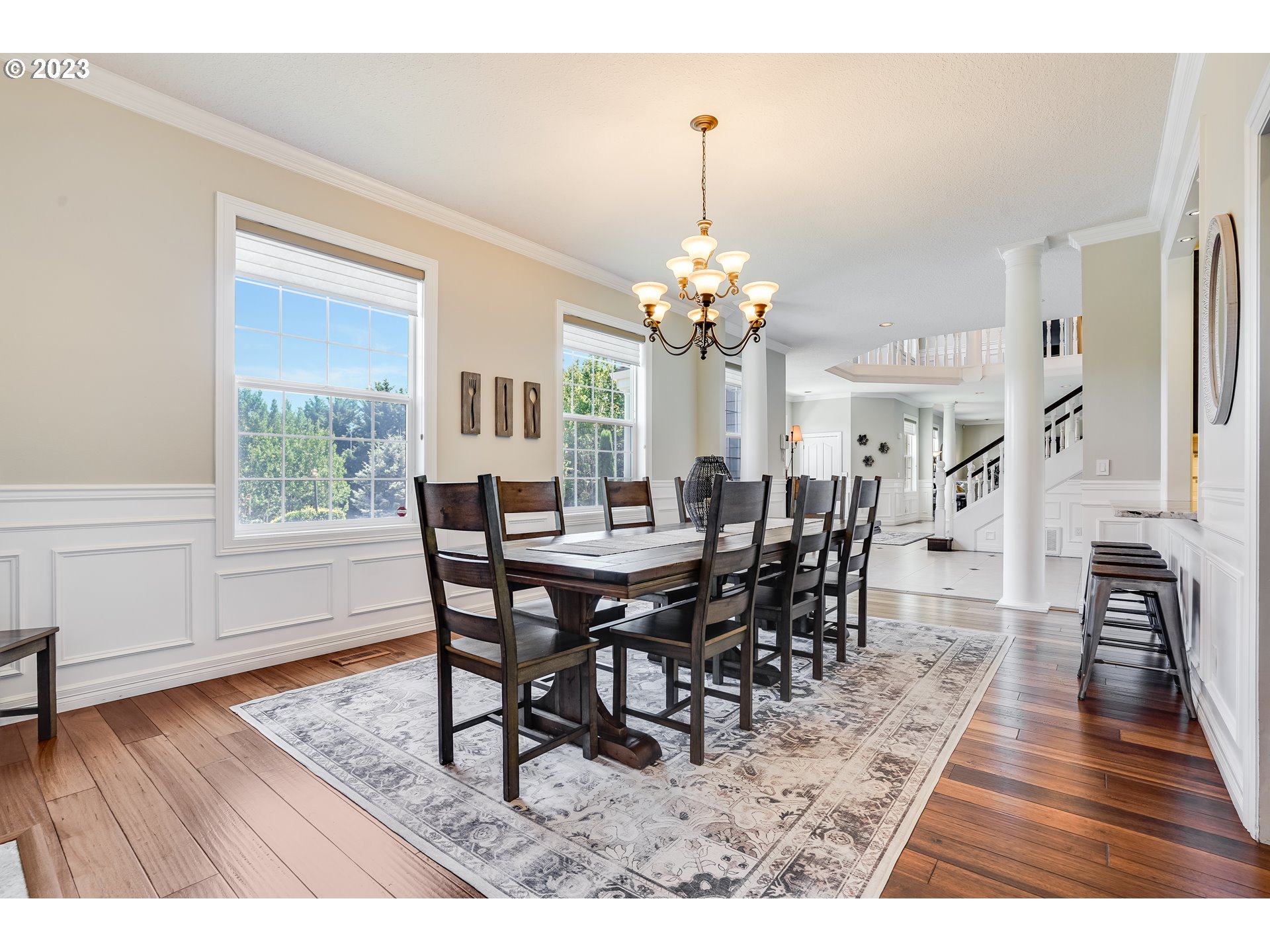 21418 Northwest 11th Avenue Ridgefield, WA 98642 - Photo 12 of 42 a dining room with furniture wooden floor a rug a potted plant and a chandelier