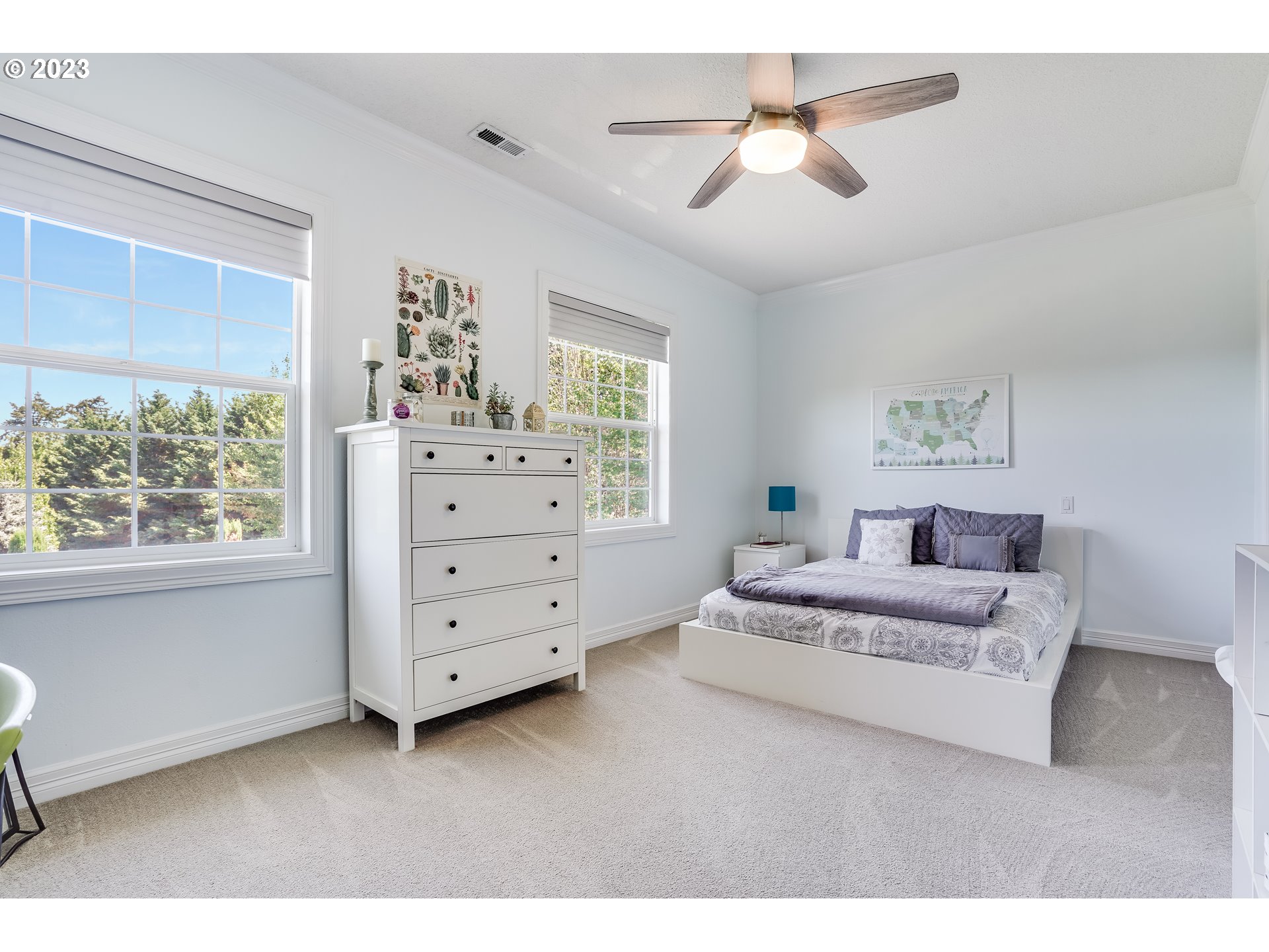21418 Northwest 11th Avenue Ridgefield, WA 98642 - Photo 22 of 42 a bedroom with a bed and a chandelier
