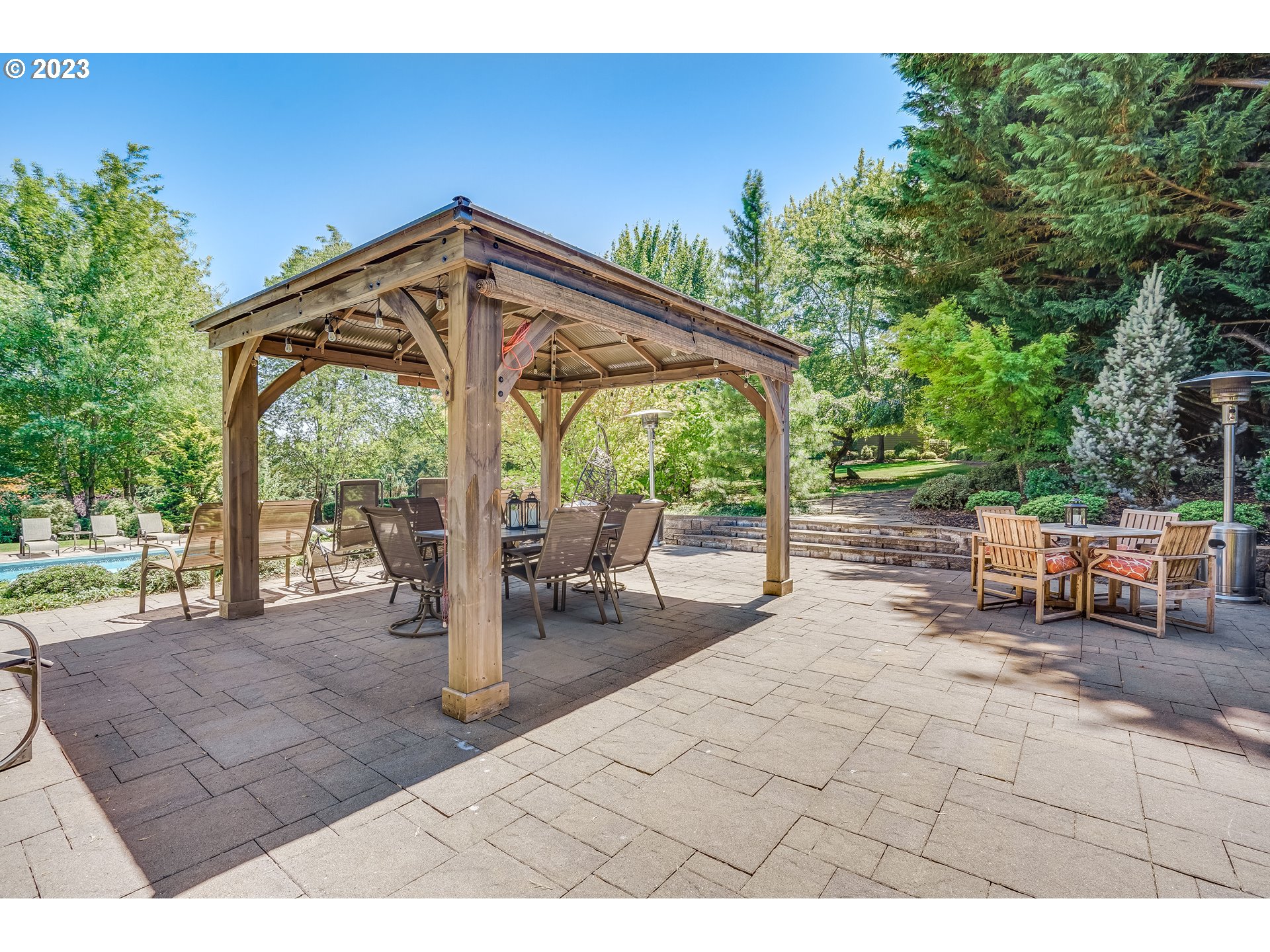 21418 Northwest 11th Avenue Ridgefield, WA 98642 - Photo 32 of 42 a view of a patio with a table chairs and a backyard