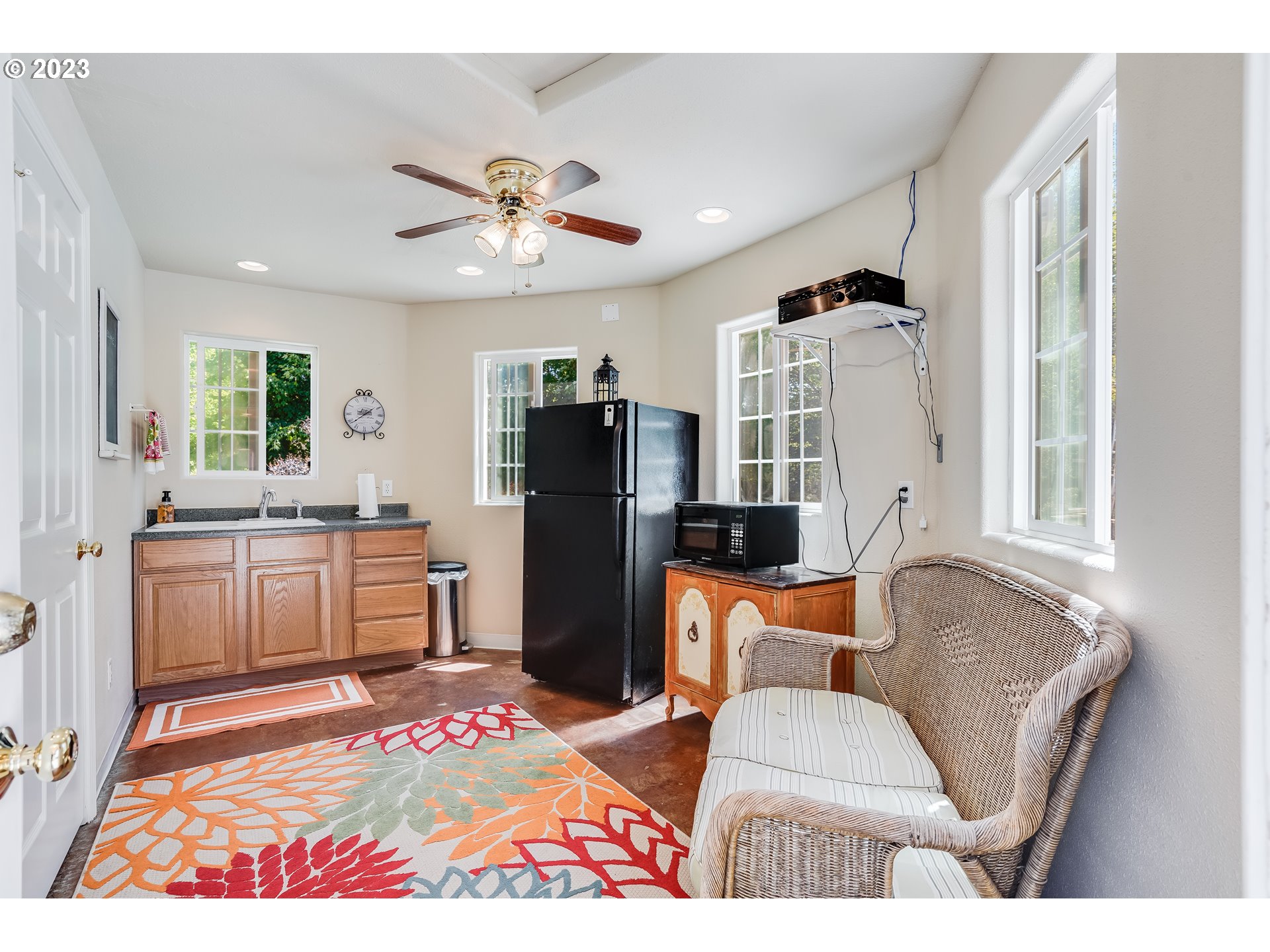 21418 Northwest 11th Avenue Ridgefield, WA 98642 - Photo 35 of 42 a living room with furniture a refrigerator and a fireplace