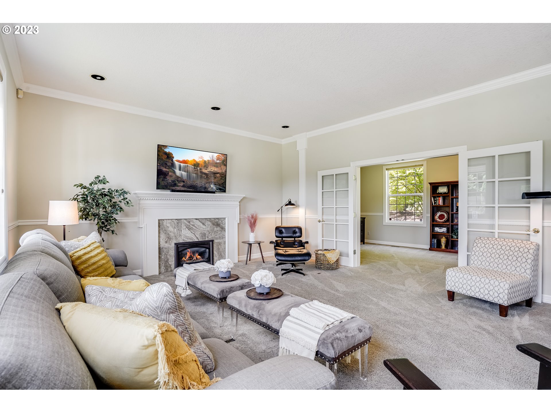 21418 Northwest 11th Avenue Ridgefield, WA 98642 - Photo 6 of 42 a living room with furniture a fireplace and a flat screen tv